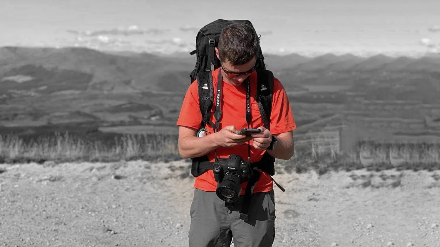 Scott Green standing on a Saddleworth moorland ridge overlooking rolling hills and reservoir, cinematic portrait for MUVE®.